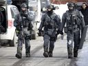 Members of the Montreal Police SWAT team return to their vehicle after an intervention on a house at DDO on February 13.