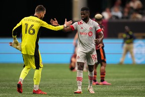 Toronto FC defender Kemar Lawrence (92) and goalkeeper Quentin Westberg celebrate after drawing with Atlanta United FC.