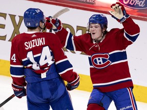 Montreal Canadiens right wing Cole Caufield celebrates center Nick Suzuki's goal against the Toronto Maple Leafs in Montreal on April 28, 2021.