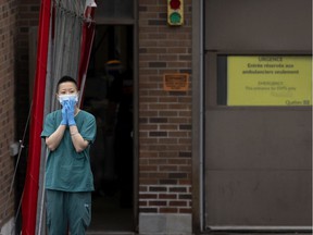 A healthcare worker takes a short break outside the triage area of ​​the St. Mary's Hospital emergency room in Montreal on Thursday, Oct. 14, 2021.
