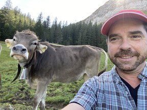 Christof Marti approaches a cow on Mount Pilatus.
