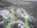 Police markings delineate an area where bloodstains mark the site of a stabbing in Marc-Aurèle-Fortin park north of Montreal on Thursday, Jan.2, 2020.