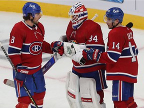 Montreal Canadiens goalkeeper Jake Allen was congratulated by teammates Ben Chiarot, left, and Nick Suzuki after shutting out the Detroit Red Wings in Montreal on November 2, 2021.