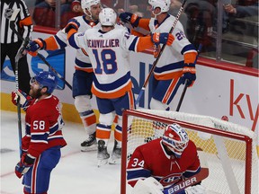 Canadiens defender David Savard and goalkeeper Jake Allen react after Islanders players celebrate one of Brock Nelson's second-period goals Thursday night at the Bell Center.
