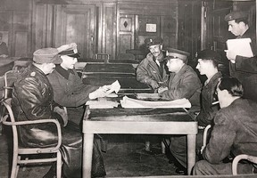 George Molnar, seated second from right, helps translate the German surrender to the Canadians on March 4, 1945.