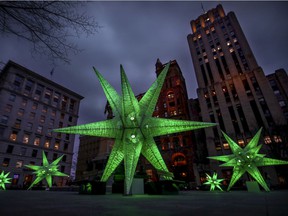 Christmas decorations light up at dusk on Place d