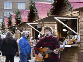 André performs traditional Québec music as he entertains people at the Christmas market in downtown Montreal on Sunday, November 21, 2021.