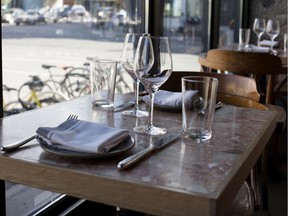 A table is empty in a Montreal restaurant. "While not showing up for a corporate restaurant is a cold statistic, for an independent restaurant it's personal." writes restorer David Ferguson.