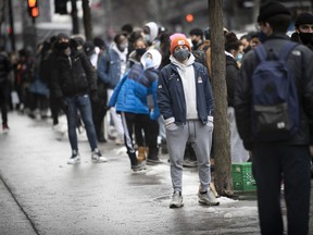 Montreal shoppers queue for Black Friday sales at Ste-Catherine on Friday, November 27, 2020.