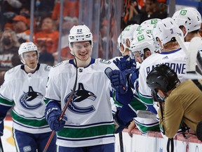 Rookie Vasily Podkolzin is greeted after scoring his first career NHL goal on Oct. 15 in Philadelphia against the Flyers.