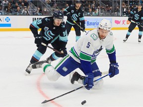 Vancouver Canucks defender Tucker Poolman, seen here Oct. 23 against the Seattle Kraken, faces suspension for hitting Colorado's Kiefer Sherwood over the head with his baton Thursday night.