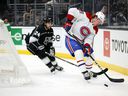 Canadiens' Christian Dvorak skates the puck against former Hab Phillip Danault (24) of the Los Angeles Kings in the first period at the Staples Center on Saturday, Oct. 30, 2021, in Los Angeles.
