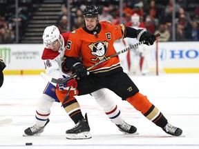 Ryan Getzlaf of the Anaheim Ducks faces Nick Suzuki of the Canadiens for a loose disc at the Honda Center on Sunday, October 31, 2021, in Anaheim, California.