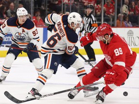 Kailer Yamamoto # 56 of the Edmonton Oilers tries to get around Sam Gagner # 89 of the Detroit Red Wings during the first period at Little Caesars Arena on November 9, 2021 in Detroit, Michigan.