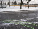 Police markings delineate an area where bloodstains mark the site of a stabbing in Marc Aurèle Fortin Park north of Montreal on Thursday, Jan.2, 2020. 