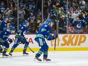 Canucks rookie winger Vasily Podkolzin heads to the bench to high-fives some teammates after scoring against Rangers goalkeeper Igor Shesterkin early in the third period of Tuesday's NHL game at Rogers. Sand.