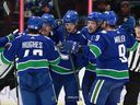 Elias Pettersson (center) of the Vancouver Canucks is congratulated by his teammates after scoring during their NHL game against the Dallas Stars at Rogers Arena on Sunday.