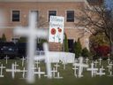 Crosses honoring veterans are seen on the front lawn of Villanova Catholic High School on Monday, November 8, 2021.