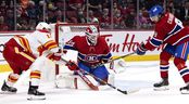 Montreal Canadiens defender Ben Chiarot (8) hits the puck away from Montreal Canadiens goalkeeper Jake Allen, while Calgary Flames left wing Matthew Tkachuk (19) looks for a rebound during action of the second NHL period in Montreal on Thursday, November 11, 2021.