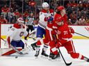 Canadiens goalkeeper Sam Montembeault (35) saves as defender Ben Chiarot (8) pushes Red Wings' Tyler Bertuzzi (59) and Dylan Larkin (71) in the second period at Little Caesars Arena in Detroit on Saturday, July 13. November 2021.. 