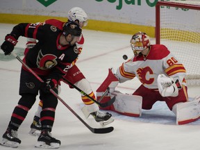 Calgary Flames goalkeeper Dan Vladar (80) saves off Ottawa Senators left wing Nick Paul (21) in the third period at the Canadian Tire Center.