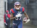Alouettes' Eugene Lewis runs with the ball after scoring a touchdown against the Winnipeg Blue Bombers in Montreal on Saturday, Nov. 13, 2021.
