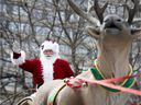 Santa greets the crowd during the annual Santa Claus Parade in Montreal on November 23, 2019.