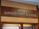 A poster for the Ontario Superior Court of Justice is displayed in Windsor.