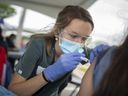 Gemma Fontanin, a University of Windsor nursing student, administers a COVID-19 vaccine at an pop-up vaccination clinic in downtown Windsor, Tuesday, July 13, 2021.  