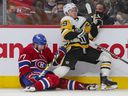 Canadiens 'Brett Kulak drags Penguins' Jake Guentzel during the second period Thursday night at the Bell Center.