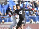 MONTREAL, QC - NOVEMBER 21: Toronto FC's Michael Bradley # 4 and CF Montréal's Romell Quioto # 30 battle for the ball in the first half during the 2021 Canadian Championship Final at Stade Saputo on November 21, 2021 in Montreal , Canada.  (Photo by Minas Panagiotakis / Getty Images) ORG XMIT: 775736294