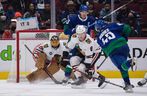 Chicago Blackhawks goalkeeper Marc-Andre Fleury, back left, stops a shot by Quinn Hughes (43) of the Vancouver Canucks as Jake McCabe (6) of Chicago defends and Bo Horvat of Vancouver (53) watches during the NHL's first period hockey action in Vancouver, BC.  Sunday, November 21, 2021. 