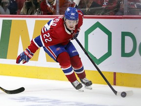Canadiens' Cole Caufield controls the puck with one hand during the third period against the Pittsburgh Penguins in Montreal on Thursday, Nov. 18, 2021.