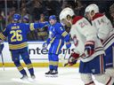 Sabers 'Kyle Okposo and defender Rasmus Dahlin celebrate after Okposo's goal during the second period as Candiens' Chris Wideman and Nick Suzuki, right, skate away. 