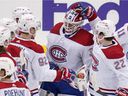 Canadiens goalkeeper Jake Allen celebrates with his teammates after a win over the Pittsburgh Penguins in Pittsburgh on Saturday, Nov. 27, 2021.