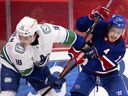 Brendan Gallagher (11) of Canadiens tries to shake off Jake Virtanen (18) of Vancouver Canucks in Montreal on March 20, 2021.  