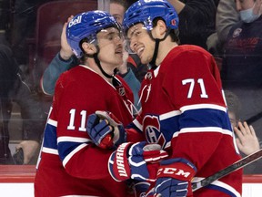 Montreal Canadiens right wing Brendan Gallagher (11) and Montreal Canadiens center Jake Evans (71) celebrate the goal during NHL third-period action against the Calgary Flames in Montreal, Thursday, 11 November 2021.