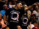 Supporters in QAnon logo T-shirts chat before US President Donald Trump takes the stage during his Make America Great Again rally in Wilkes-Barre, Pennsylvania on August 2, 2018. 