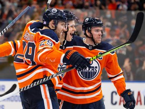 Edmonton Oilers Jesse Puljujarvi (13) celebrates a goal over New York Rangers goalkeeper Alexandar Georgiev (40) with Leon Draisaitl (29) and Connor McDavid (97) during third period NHL action at Rogers Place in Edmonton, Friday, November 5.  , 2021.