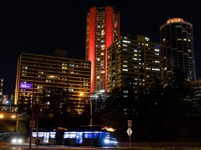 The Edmonton House condo building is lit in poppy red ahead of Remembrance Day in Edmonton, Monday, November 8, 2021. Photo by Ian Kucerak