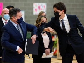 Prime Minister Justin Trudeau (right) and Alberta Prime Minister Jason Kenney bump elbows during a joint federal-provincial ad for a $ 10-a-day daycare at Boyle Street Plaza in Edmonton, Monday, Nov. 15, 2021. Photo by Ian Kucerak