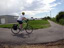 Dave Robichaud, 58, takes to the new multi-use trail near Deziel Drive after his shift at the FCA facility on Rhodes Drive on Wednesday, July 29, 2020.