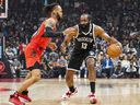 Brooklyn Nets guard James Harden (13) moves the ball against Toronto Raptors guard Gary Trent Jr. (33) during the first half at Scotiabank Arena on Sunday.