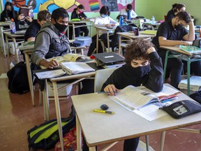 Masked students read at their desks at John F. Kennedy High School in Montreal on Tuesday, Nov. 10, 2020. Although masks are no longer required for students seated in classrooms, Fariha Naqvi-Mohamed says she is grateful that many continue to choose to use them.  .