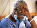 A COVID-19 patient breathes oxygen at Khayelitsha Hospital, about 35 km from central Cape Town, on December 29, 2020.