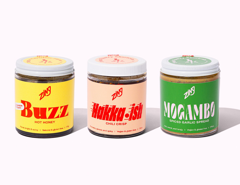 A photo of three jars of Zing products with brightly colored packaging 