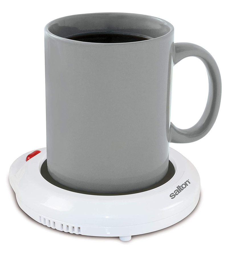 A gray mug sitting on a white electric mug warmer 