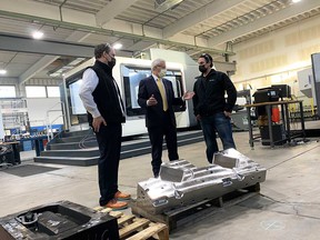 Vic Fedeli (center), Ontario's minister of economic development, speaks with Donny Butler (left) and his brother Kevin Butler (right), co-owners of Lakeshore-based tool and mold company CNCTech.com.  Photographed on November 16, 2021.