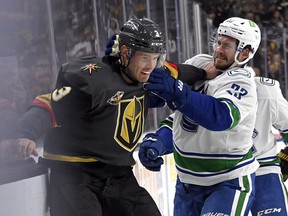 Golden Knights defender Brayden McNabb and Vancouver Canucks defender Oliver Ekman-Larsson fight in the first period at the T-Mobile Arena in Las Vegas.