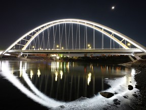 LED lighting on the Walterdale Bridge is reflected in the North Saskatchewan River near downtown Edmonton on October 31, 2021. (PHOTO BY LARRY WONG / POSTMEDIA)